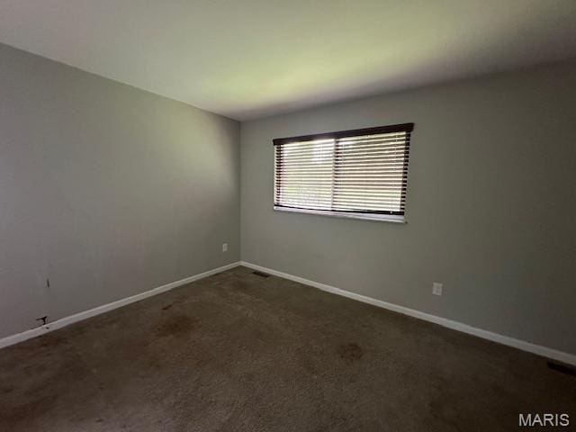 12750 Needle Point Ct, Florissant, MO 63033 - unfurnished room featuring baseboards and dark carpet