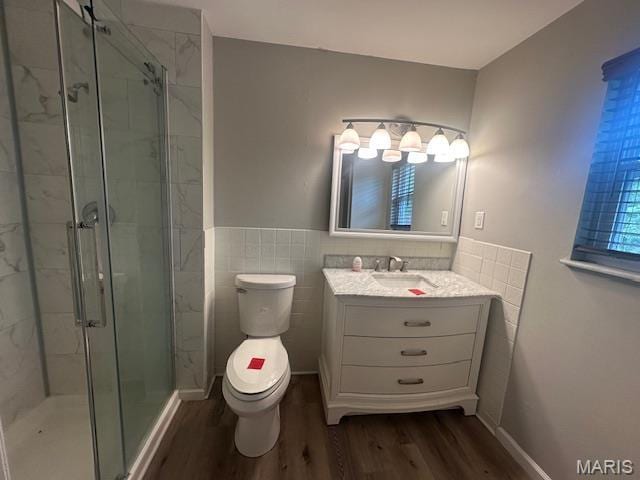 12750 Needle Point Ct, Florissant, MO 63033 - full bath with wood finished floors, a stall shower, vanity, a wainscoted wall, and tile walls