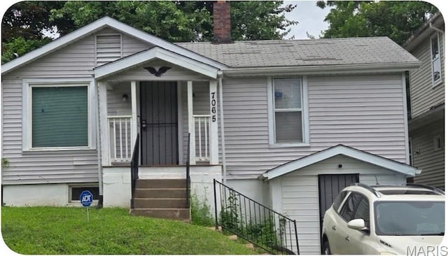7065 Idlewild Ave, Saint Louis, MO 63136 - view of front facade featuring a chimney and a shingled roof