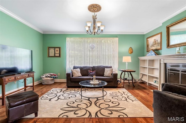 318 Doe Run Ln, Bonne Terre, MO 63628 - living room with a chandelier, crown molding, wood finished floors, and a fireplace