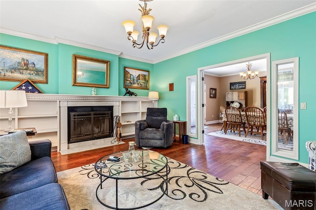 318 Doe Run Ln, Bonne Terre, MO 63628 - living area with a chandelier, ornamental molding, a fireplace with flush hearth, and wood finished floors