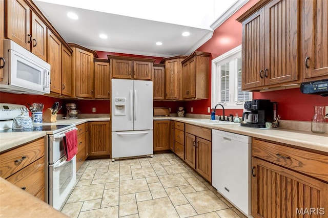 318 Doe Run Ln, Bonne Terre, MO 63628 - kitchen with white appliances, brown cabinets, light countertops, and recessed lighting