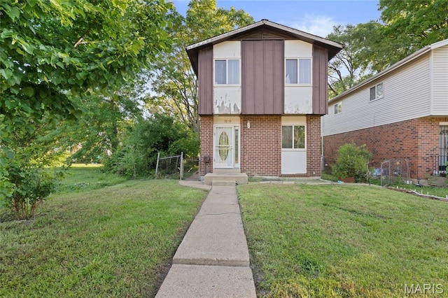 2239 University St, Saint Louis, MO 63107 - view of front facade with a front lawn and brick siding