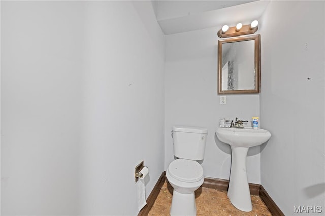 2239 University St, Saint Louis, MO 63107 - half bath featuring baseboards and toilet