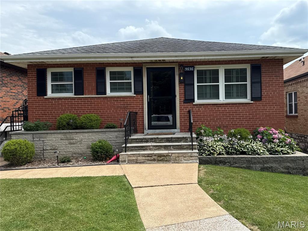 5636 Winona Ave, Saint Louis, MO 63109 - bungalow-style home with brick siding, a front yard, and roof with shingles