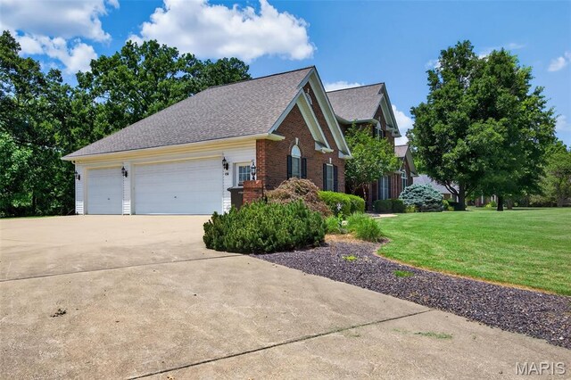 156 Bluffview Dr, Troy, MO 63379 - view of front facade with driveway, brick siding, a front yard, an attached garage, and a shingled roof