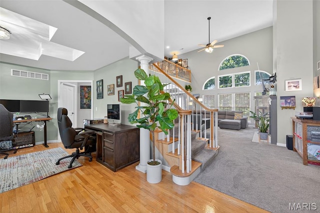 156 Bluffview Dr, Troy, MO 63379 - office space featuring a towering ceiling, ceiling fan, arched walkways, and wood finished floors