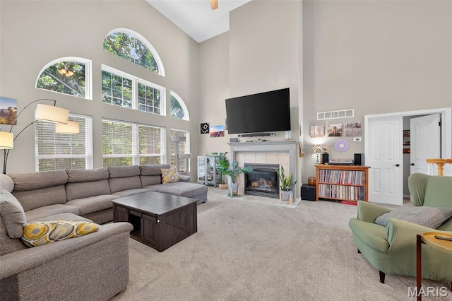 156 Bluffview Dr, Troy, MO 63379 - carpeted living area featuring high vaulted ceiling and a tiled fireplace