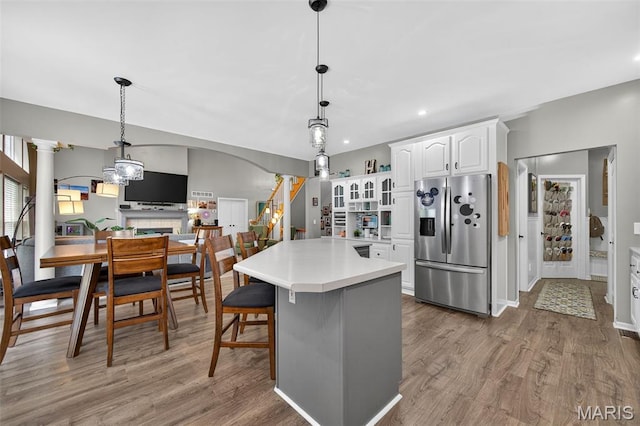 156 Bluffview Dr, Troy, MO 63379 - kitchen featuring stainless steel fridge, white cabinetry, wood finished floors, light countertops, and recessed lighting