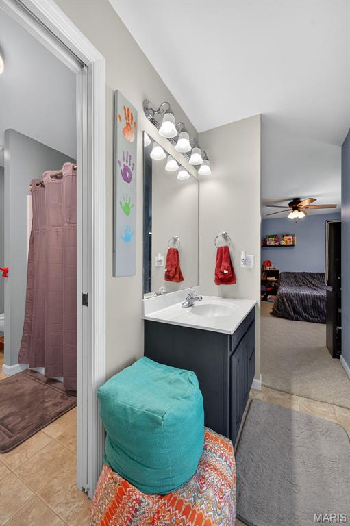 156 Bluffview Dr, Troy, MO 63379 - full bathroom with tile patterned floors, vanity, lofted ceiling, and a ceiling fan
