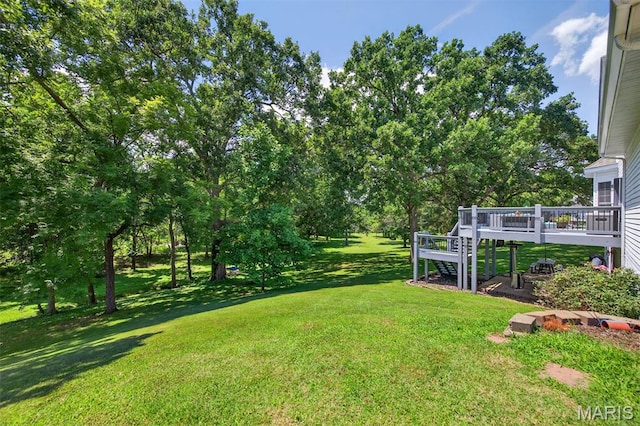 156 Bluffview Dr, Troy, MO 63379 - view of green lawn with a deck and view of wooded area