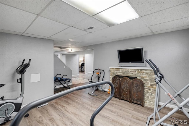 1326 Petite Dr, Saint Louis, MO 63138 - workout area with a drop ceiling and wood finished floors