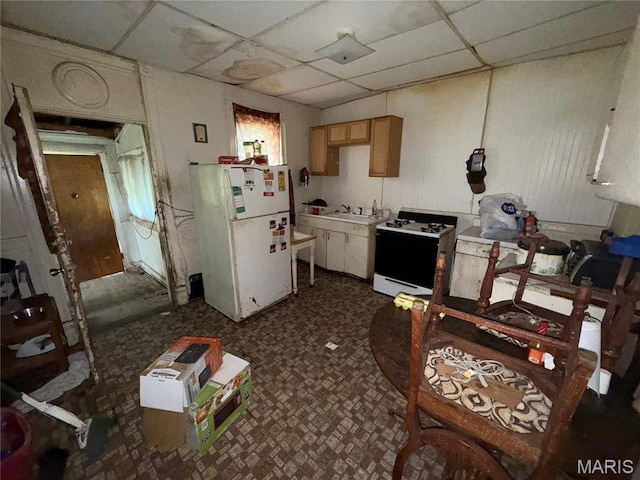 2806 Union Blvd, Saint Louis, MO 63115 - kitchen with white appliances, a paneled ceiling, dark floors, and light countertops