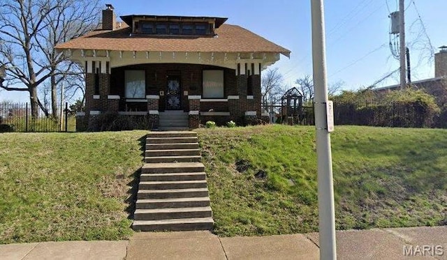 5923 Ridge Ave, Saint Louis, MO 63112 - view of front of home with covered porch, a front yard, a chimney, and brick siding