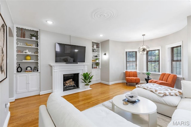 7801 Delmar Blvd Unit 2W, University City, MO 63130 - living area with light wood-style flooring, built in features, a brick fireplace, and recessed lighting