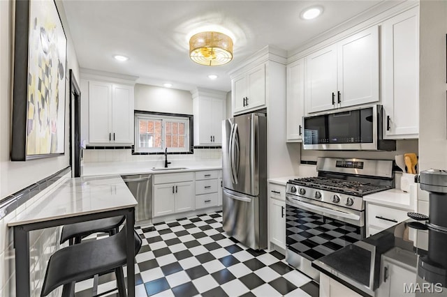 7801 Delmar Blvd Unit 2W, University City, MO 63130 - kitchen featuring stainless steel appliances, light flooring, white cabinets, light countertops, and decorative backsplash