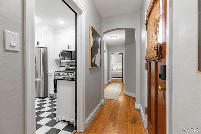 7801 Delmar Blvd Unit 2W, University City, MO 63130 - corridor featuring arched walkways and light flooring