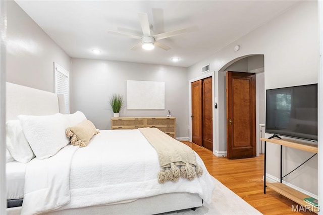 7801 Delmar Blvd Unit 2W, University City, MO 63130 - bedroom with light wood-style flooring, recessed lighting, a ceiling fan, arched walkways, and a closet