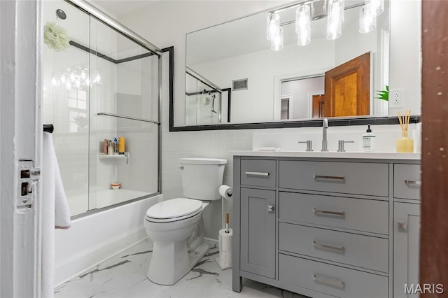 7801 Delmar Blvd Unit 2W, University City, MO 63130 - full bathroom featuring vanity, enclosed tub / shower combo, marble finish floors, and tile walls