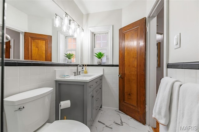 7801 Delmar Blvd Unit 2W, University City, MO 63130 - bathroom with tile walls, vanity, and marble finish floors