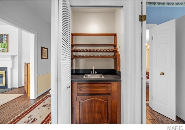 10 Jefferson Rd Unit 3A, Webster Groves, MO 63119 - indoor wet bar featuring wood finished floors and a glass covered fireplace