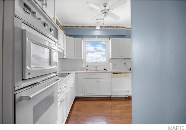 10 Jefferson Rd Unit 3A, Webster Groves, MO 63119 - kitchen with paneled dishwasher, white cabinets, dark wood-style flooring, and light countertops