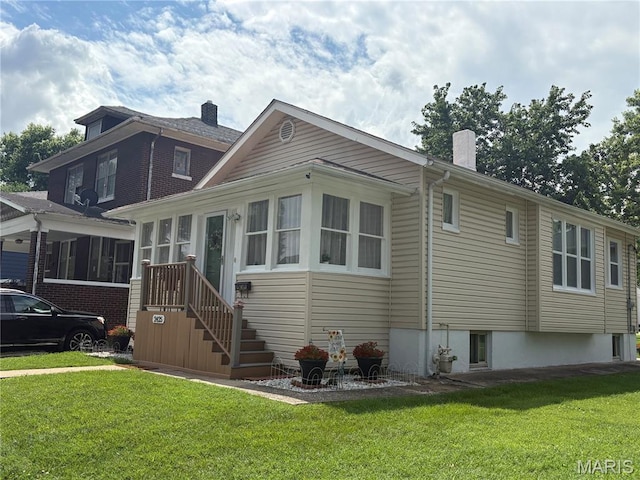 2425 State St, Granite City, IL 62040 - view of side of property with a yard, a chimney, and a sunroom