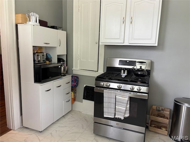 2425 State St, Granite City, IL 62040 - kitchen with stainless steel gas range, light marble finish flooring, and white cabinetry