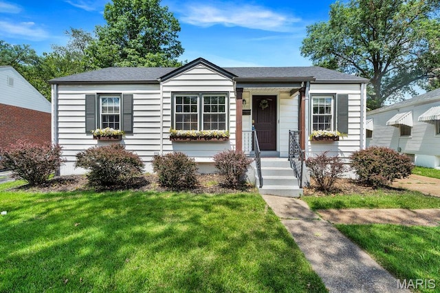 3711 Ashby Rd, Saint Ann, MO 63074 - view of front of home with a front yard and roof with shingles
