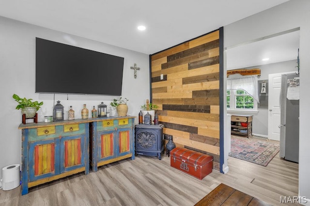 3711 Ashby Rd, Saint Ann, MO 63074 - living room with wood finished floors, a wood stove, and recessed lighting