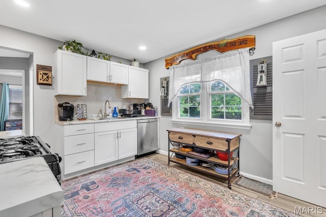 3711 Ashby Rd, Saint Ann, MO 63074 - kitchen featuring dishwasher, light countertops, white cabinetry, backsplash, and recessed lighting