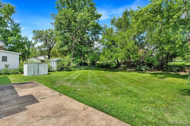 3711 Ashby Rd, Saint Ann, MO 63074 - view of yard with a storage unit and a patio