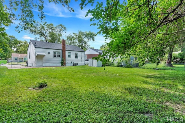 3711 Ashby Rd, Saint Ann, MO 63074 - back of house featuring a chimney and a fenced backyard