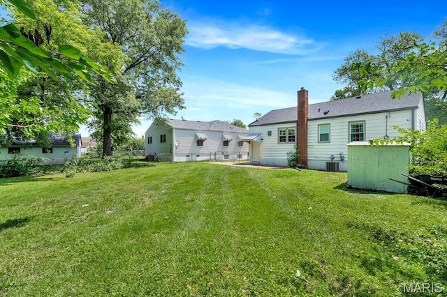 3711 Ashby Rd, Saint Ann, MO 63074 - back of house with a chimney