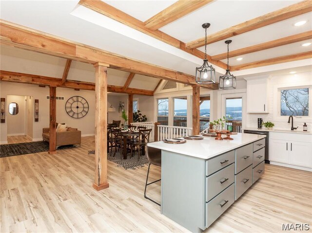 24925 State Route Mm, Farmington, MO 63640 - kitchen featuring gray cabinets, beam ceiling, light countertops, a kitchen island, and a breakfast bar area