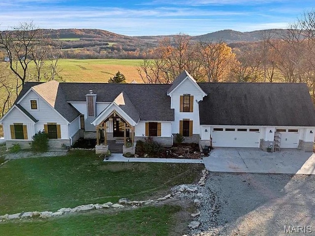 24925 State Route Mm, Farmington, MO 63640 - view of front facade featuring driveway, a mountain view, an attached garage, and a front yard