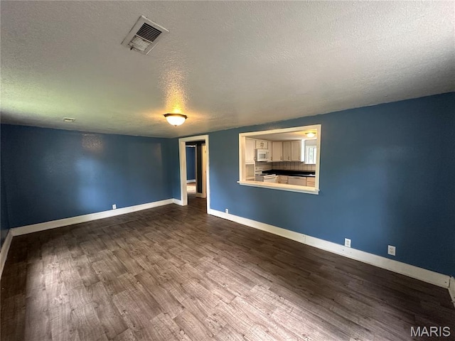 1506 S Gertrude St, Salem, MO 65560 - empty room with a textured ceiling and dark wood finished floors