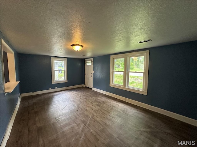 1506 S Gertrude St, Salem, MO 65560 - unfurnished room with a textured ceiling and dark wood-style floors