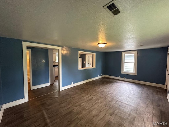 1506 S Gertrude St, Salem, MO 65560 - empty room featuring a textured ceiling and dark wood-type flooring