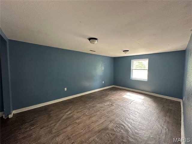 1506 S Gertrude St, Salem, MO 65560 - empty room featuring a textured ceiling and dark wood finished floors