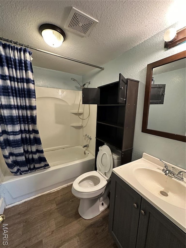 1506 S Gertrude St, Salem, MO 65560 - full bathroom with wood finished floors, shower / bathtub combination with curtain, vanity, a textured wall, and a textured ceiling