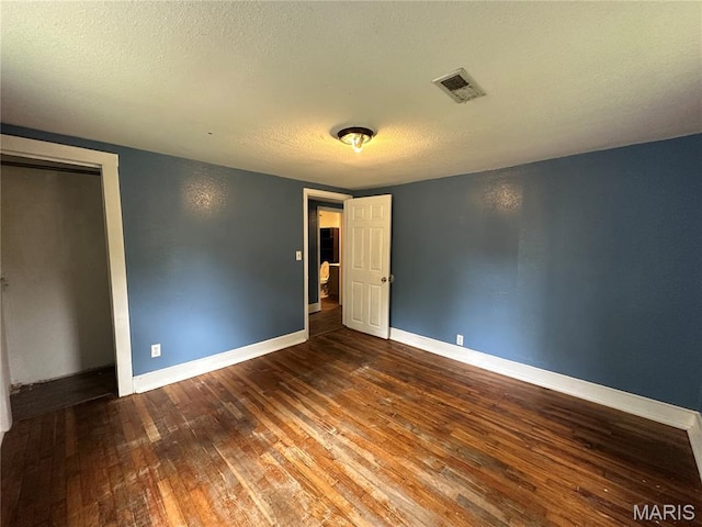 1506 S Gertrude St, Salem, MO 65560 - unfurnished bedroom with wood-type flooring, a textured ceiling, and a closet