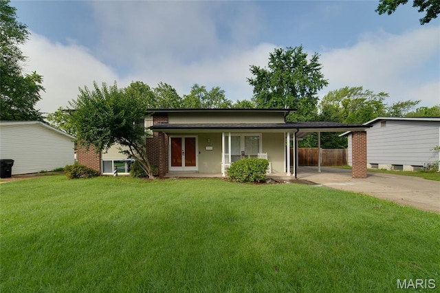 1340 Central Pkwy, Florissant, MO 63031 - view of front of property with driveway, a carport, brick siding, and a porch
