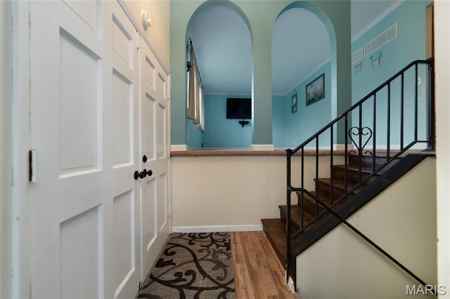 1340 Central Pkwy, Florissant, MO 63031 - foyer entrance with wood finished floors, stairs, and ornamental molding