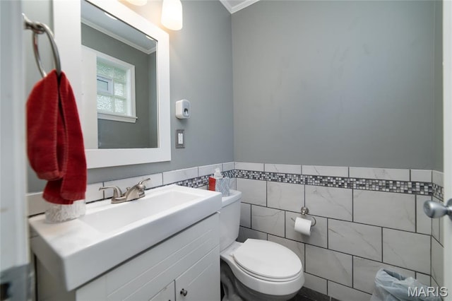 1340 Central Pkwy, Florissant, MO 63031 - bathroom with crown molding, tile walls, vanity, and a wainscoted wall