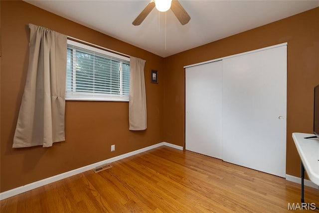 1340 Central Pkwy, Florissant, MO 63031 - unfurnished bedroom with light wood-type flooring, a closet, and a ceiling fan