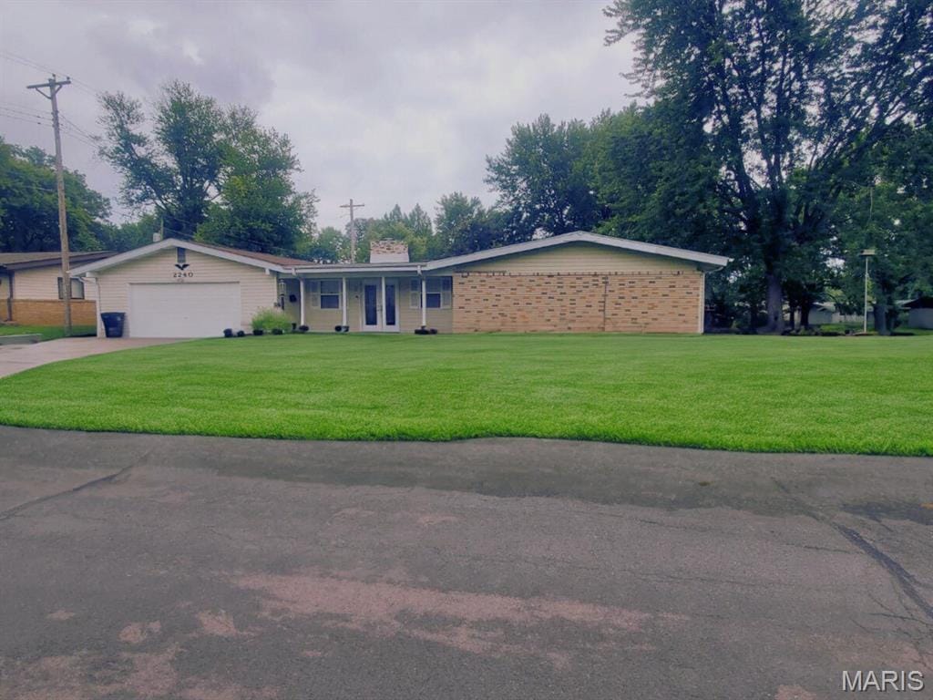 2240 Brook Dr, Florissant, MO 63033 - ranch-style home with a garage, driveway, a front lawn, and a chimney