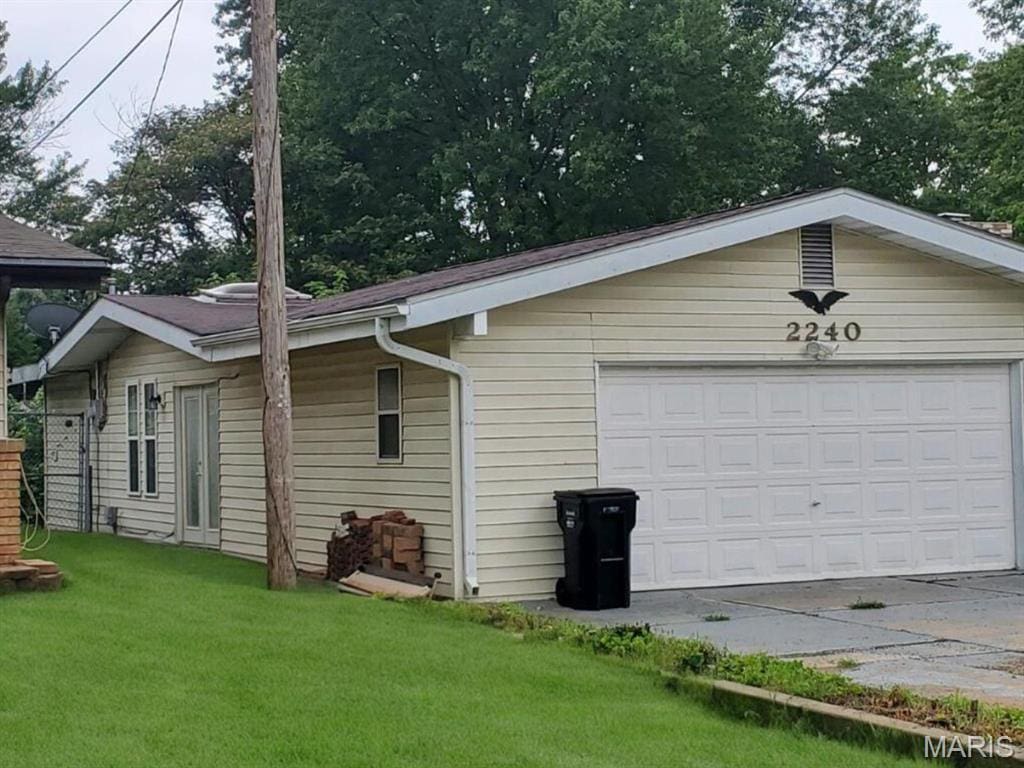 2240 Brook Dr, Florissant, MO 63033 - view of property exterior with a lawn