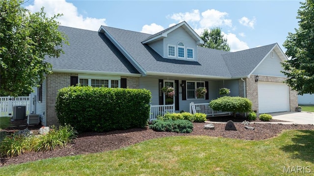 408 Marty Graten Ct, Hamel, IL 62046 - new england style home with covered porch, a garage, brick siding, and roof with shingles