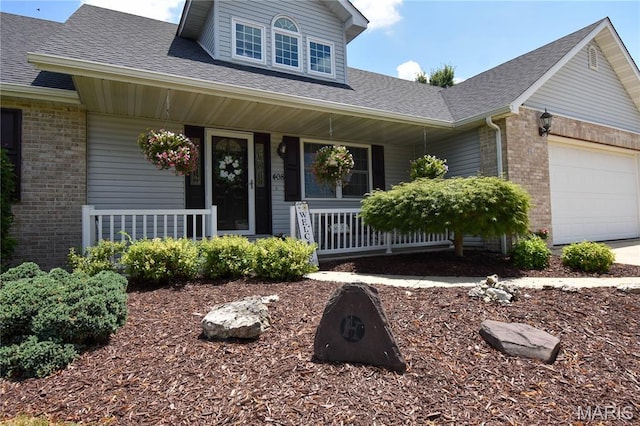 408 Marty Graten Ct, Hamel, IL 62046 - view of front facade with a porch, brick siding, a garage, and a shingled roof
